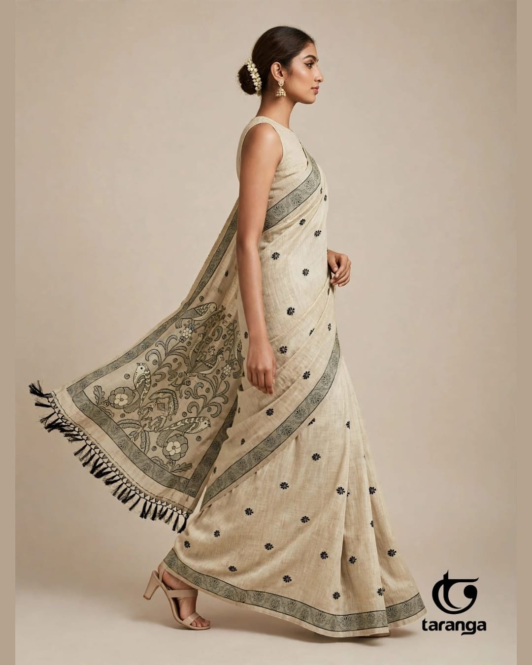 Cream saree with a flowing bird-patterned pallu