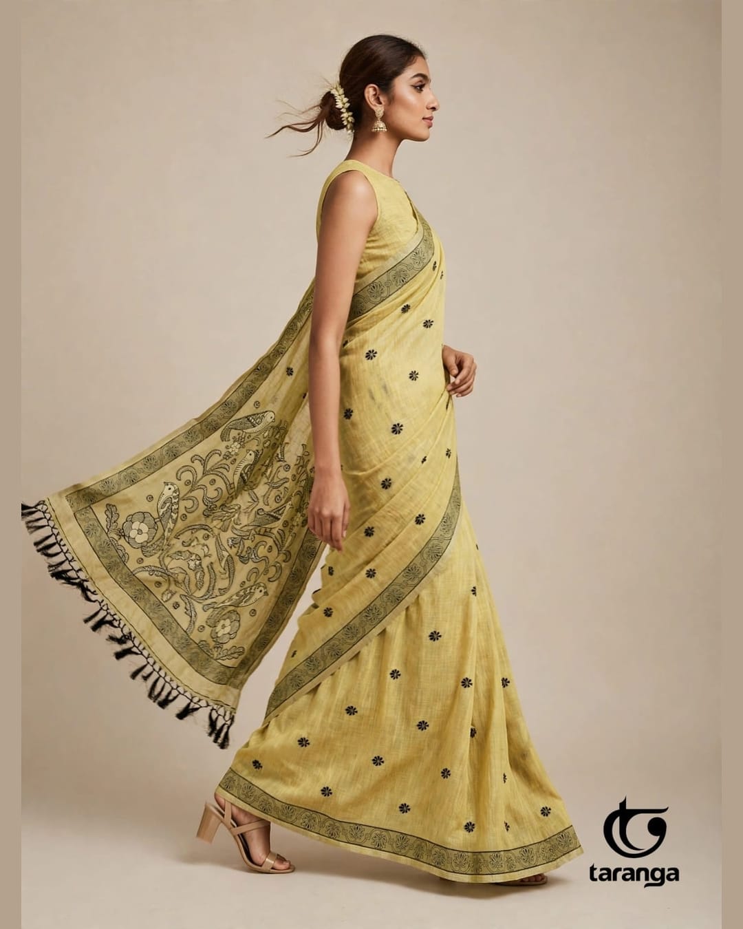 Yellow saree with a flowing pallu